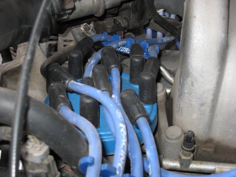 1994 Ford Bronco - Close-up view of a vehicle's engine distributor cap and spark plug wires.