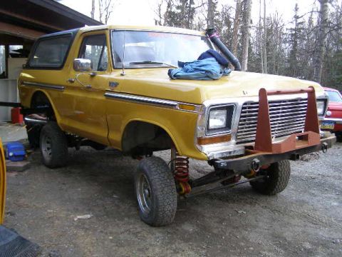1978 Ford Bronco - This lifted SUV features a prominent bull bar and a snorkel, suggesting off-road use.