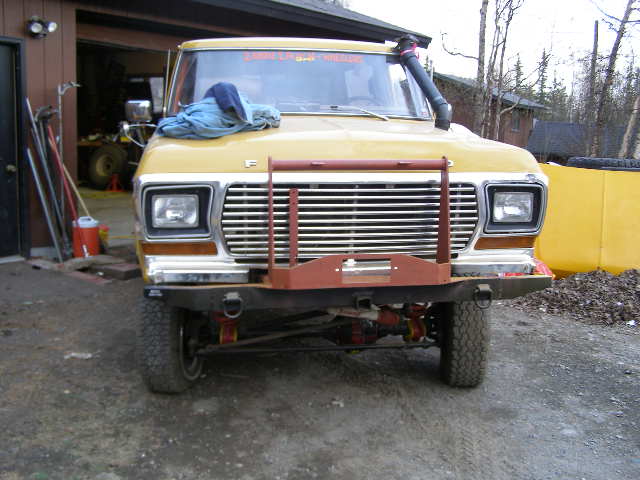 Yellow 1978 Ford Bronco front view with a snorkel and winch bumper