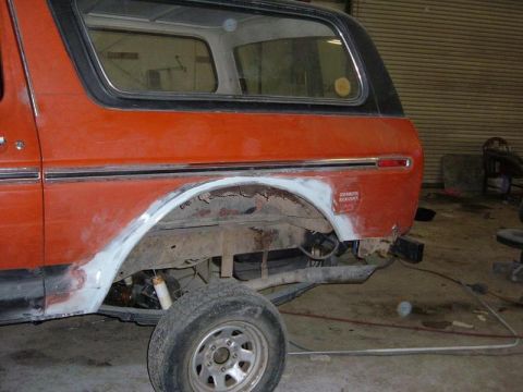 1978 Ford Bronco - Rear quarter panel of a 1978 Ford Bronco undergoing rust repair and bodywork.
