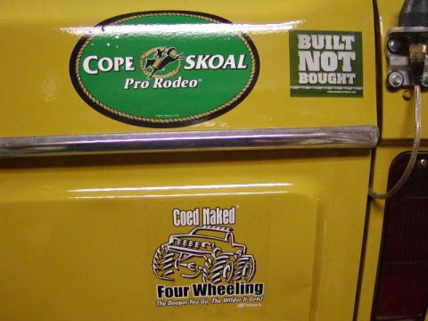1978 Ford Bronco - A yellow vehicle's side panel displays multiple stickers, including one for 'COPE SKOAL Pro Rodeo'.