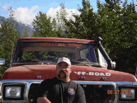 1978 Ford Bronco - A man stands in front of a red off-road truck with a snorkel and "OFF-ROAD" printed on the hood.