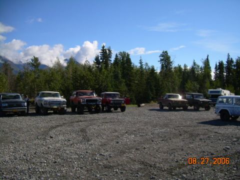 1978 Ford Bronco - Multiple SUVs and trucks are parked in a gravel lot with trees and mountains in the background. The date stamp indicates August 27, 2006.
