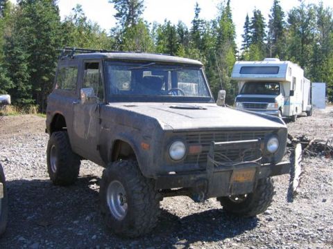 1978 Ford Bronco - This modified 1978 Ford Bronco is parked on a gravel lot, with an RV visible behind it.
