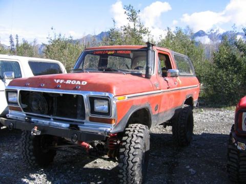 1978 Ford Bronco - This modified 1978 Ford Bronco is ready for off-road adventures, parked outdoors with mountains in the background.