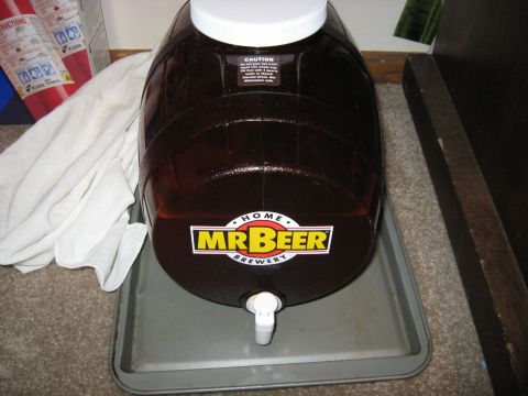 1994 Ford Bronco - A Mr. Beer home brewing kit sits on a tray, filled with dark liquid and topped with a white lid.