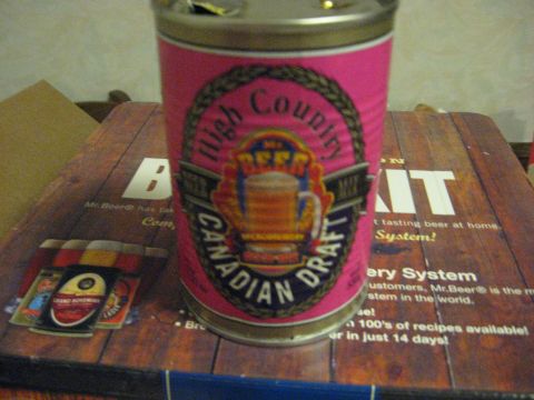 1994 Ford Bronco - A beer can and coasters are placed on a wooden surface with text about a beer system.