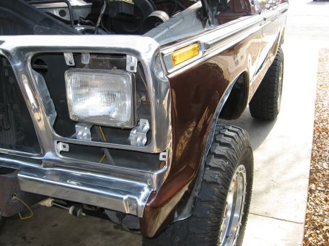 1979 Ford Bronco - Front view of a brown 1979 Ford Bronco, showing the fender, headlight, and chrome grille surround.