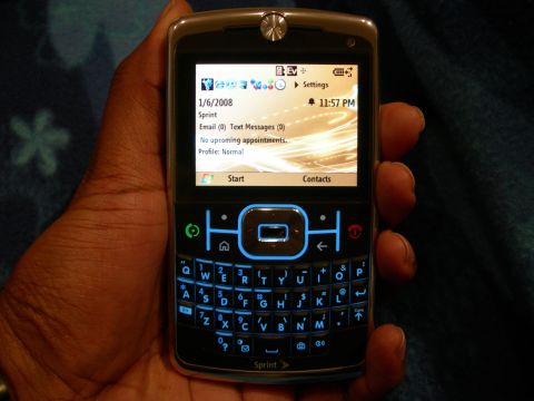 1992 Ford Taurus - Motorola Q cell phone with illuminated keyboard and screen displaying date and time.