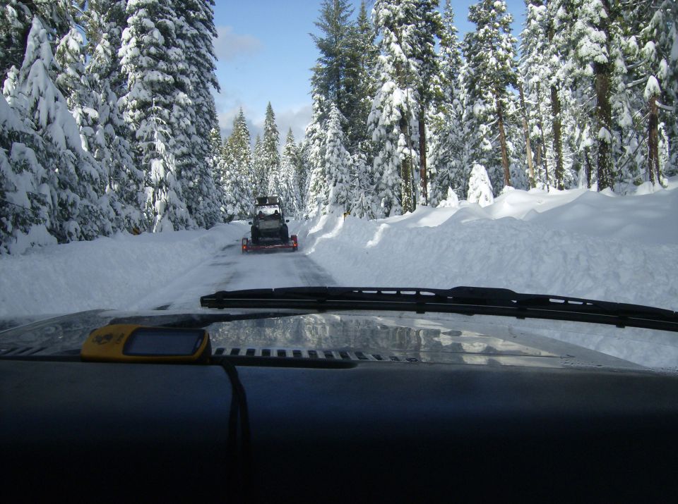 Snowmobile on a snow-covered road through a forest