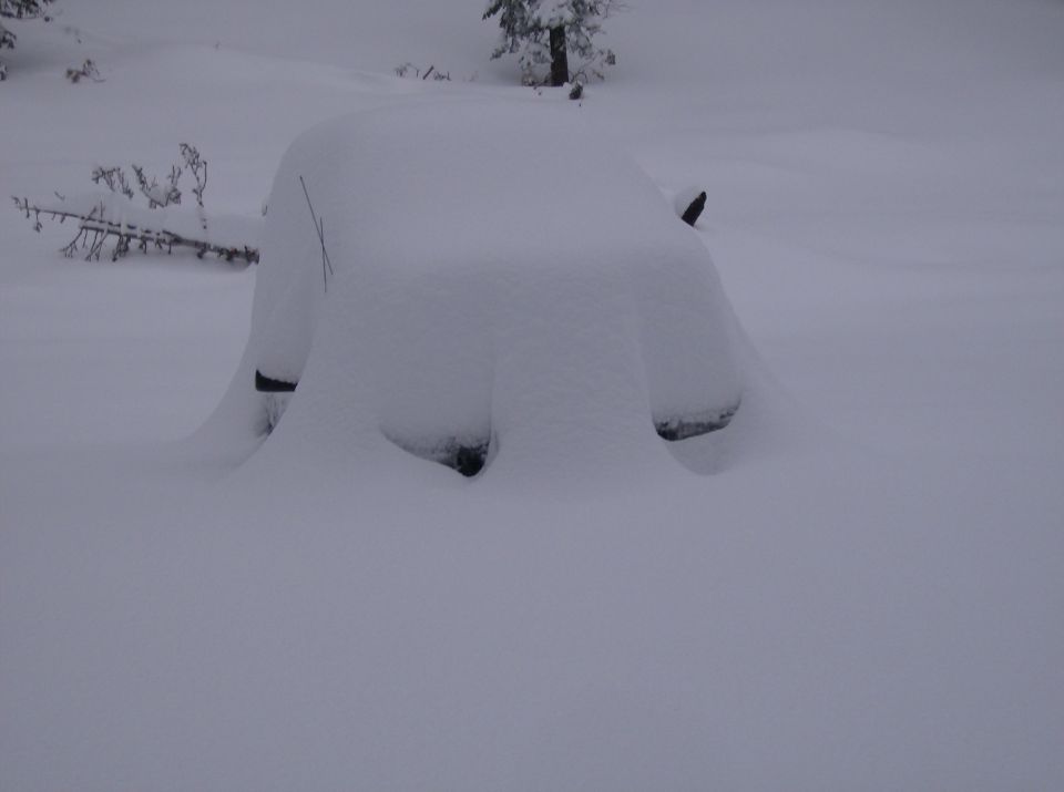 Vehicle covered in snow, front 3/4 view