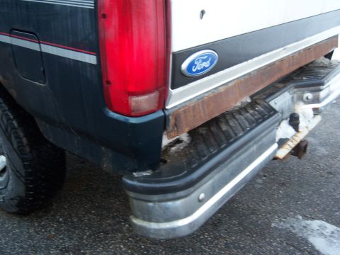 1995 Ford Bronco - Close-up of the rear bumper and taillight assembly on a 1995 Ford Bronco.
