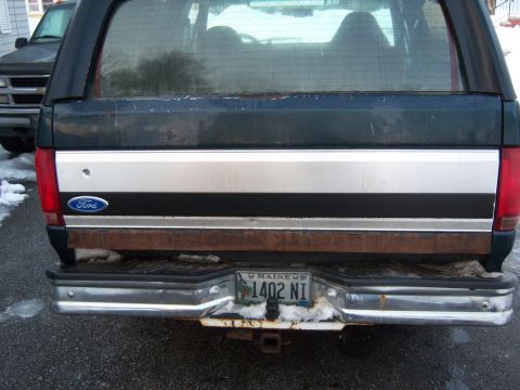 1995 Ford Bronco - The rear of a Ford Bronco shows its license plate and a silver stripe detail.