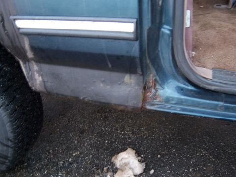 1995 Ford Bronco - This 1995 Ford Bronco shows significant rust on the rocker panel and door sill, indicating potential structural compromise.