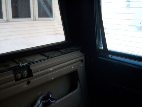 1995 Ford Bronco - View from inside a vehicle, showing the door panel and a window.