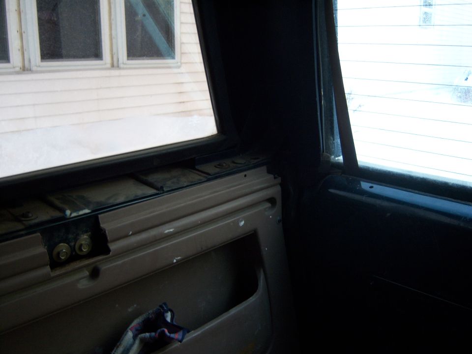 Interior door panel with a pocket and a window looking out at a house