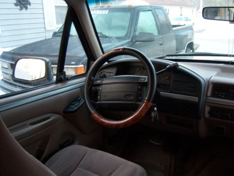 1995 Ford Bronco - Interior view of a truck, with another truck visible outside.