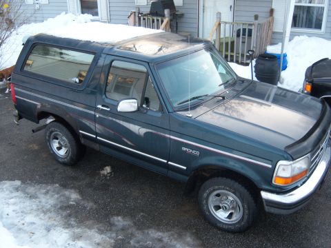 1995 Ford Bronco - This 1995 Ford Bronco is seen from a 3/4 front angle, with snow on its roof and surrounding the vehicle.