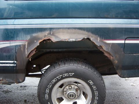 1995 Ford Bronco - Significant rust damage is visible on the rear wheel well of this 1995 Ford Bronco.
