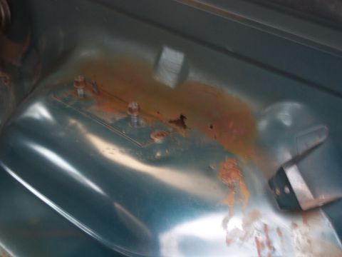 1995 Ford Bronco - The interior floor pan shows signs of rust and corrosion around mounting points.