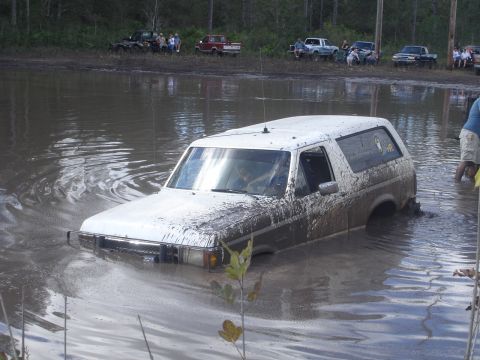1989 Ford Bronco - Mud bogging event with a 1989 Ford Bronco submerged in water.