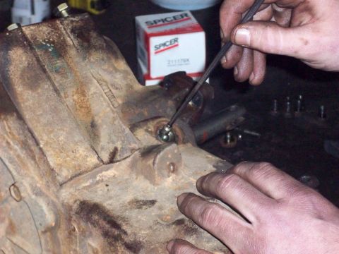 1978 Ford Bronco - Mechanic works on a transfer case component, with a Spicer parts box visible.