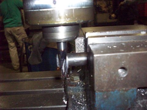 1978 Ford Bronco - A milling machine is used to cut a metal component, with shavings accumulating around the workpiece.