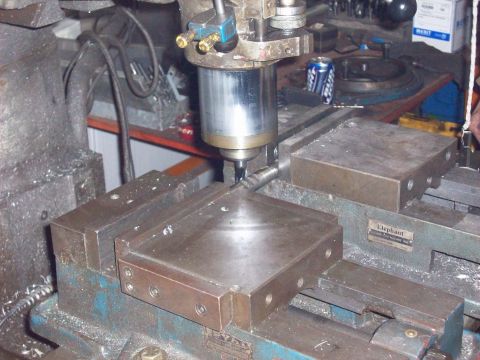1978 Ford Bronco - Milling machine in operation, cutting a metal part held securely in a vise.