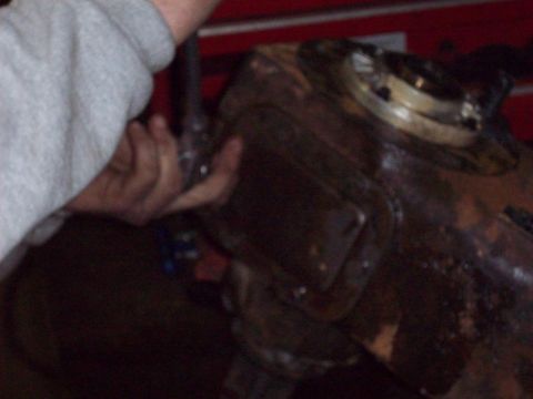 1978 Ford Bronco - Mechanic working on a vehicle's transfer case.