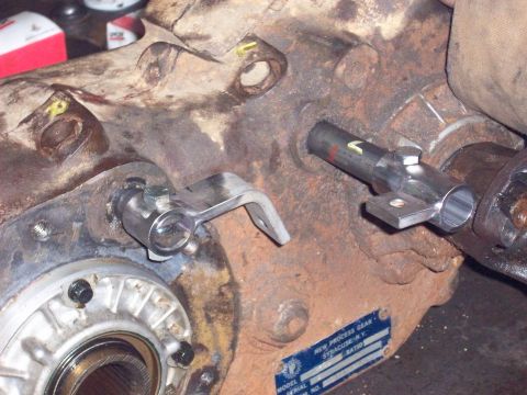 1978 Ford Bronco - This image shows a close-up of a vehicle's transfer case linkage, with a data plate visible.