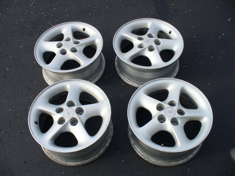 four silver 5-spoke alloy wheels