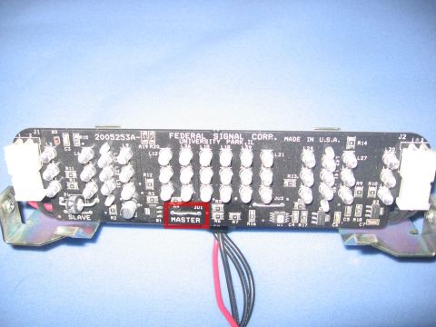2000 Ford Crown Victoria - A close-up view of a Federal Signal Corp. circuit board with multiple LEDs and connectors.