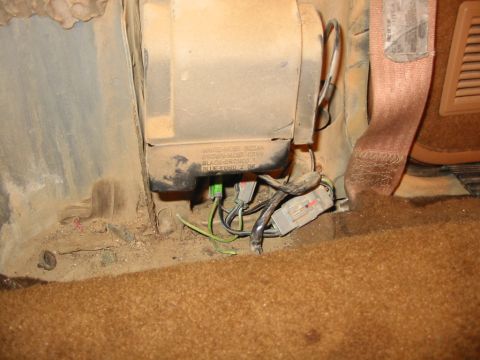 1988 Ford Bronco - This is a view of the wires behind the driver side seatbelt retractor panel. The green wire had corroded on the connector and preventing po…