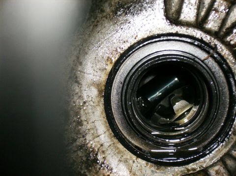 1995 Ford Probe - A close-up view of a greasy engine component, possibly a bearing or seal, with visible internal workings.