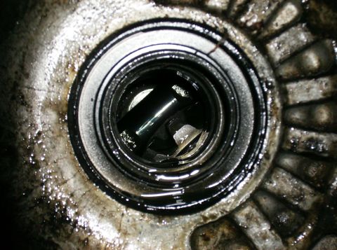 1995 Ford Probe - Close-up of a greasy mechanical component, likely from an engine or transmission.