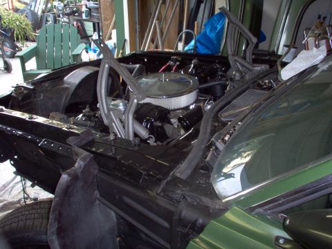 1970 Ford Ranchero - The engine compartment of a car is shown with the hood removed, revealing the engine and surrounding components.