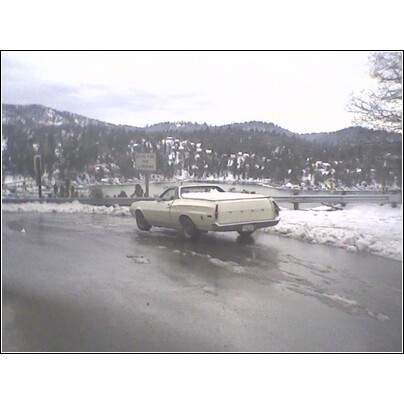 1972 Ford Ranchero - 1972 Ford Ranchero in a snowy, wet environment with a lake and mountains visible.
