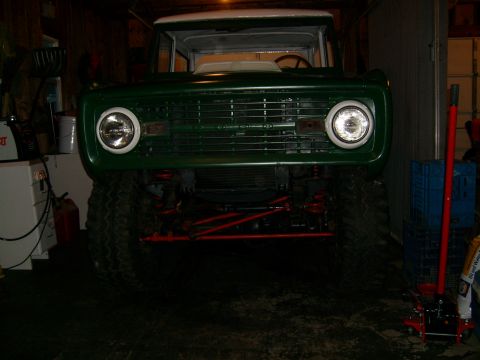 1974 Ford Bronco - This 1974 Ford Bronco is parked indoors with its front end prominently displayed, showing off its lifted suspension.