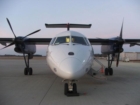 1989 Ford Bronco - A twin-engine turboprop airplane is parked on the tarmac under a dusky sky.