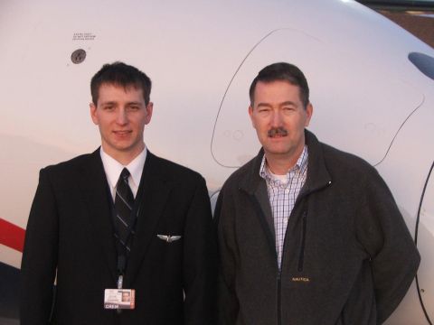 1989 Ford Bronco - A pilot and another man pose for a photo in front of a white aircraft.