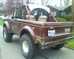 1973 Ford Bronco - This 1973 Ford Bronco is shown from the rear, its distinctive body style, large off-road tires, and a white soft top.