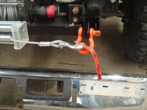 1996 Ford Bronco - Winch and tow strap connected to the front bumper of a 1996 Ford Bronco.