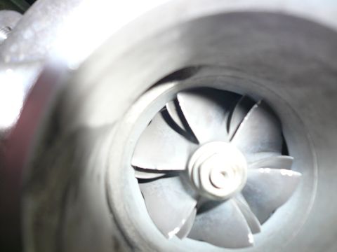 1996 Ford Probe - Close-up of a turbocharger's compressor wheel, showing its angled blades.