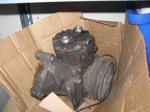 1995 Ford Bronco - This is a used air conditioning compressor, likely removed from a vehicle for repair or replacement.