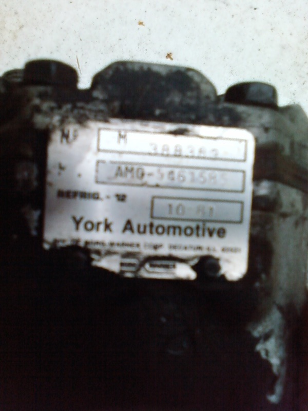 York Automotive air conditioning compressor with label showing part number AMO-5461585 and date 10-91