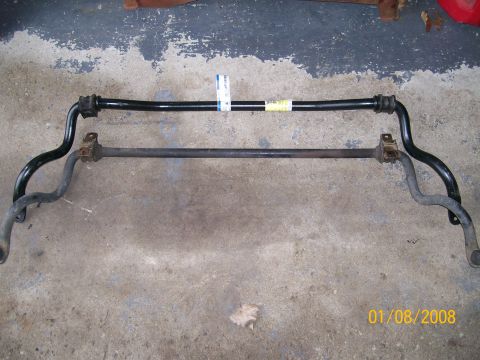 1995 Mercury Grand Marquis - Two sway bars are shown on a concrete surface, one appearing to be a replacement part.