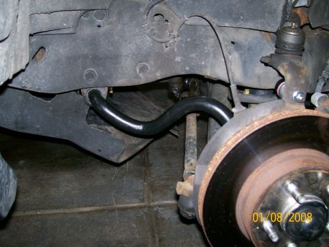1995 Mercury Grand Marquis - Close-up view of a vehicle's front sway bar and suspension system.