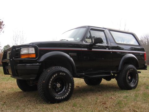 1967 Ford Mustang - This black Ford Bronco is shown from a 3/4 front angle, parked outdoors on a grassy area.