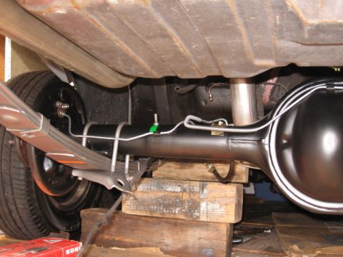 1968 Shelby GT500 - Close-up view of the rear axle and suspension components, including brake lines and leaf springs.