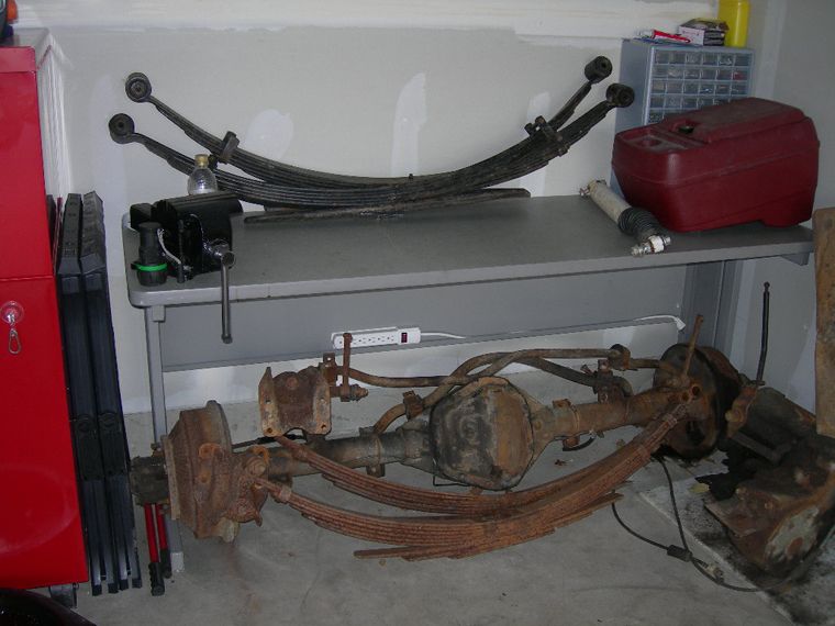 Rear 6" chevy leaf packs with old ford stock f250 under the table. Rear dana 60 also.